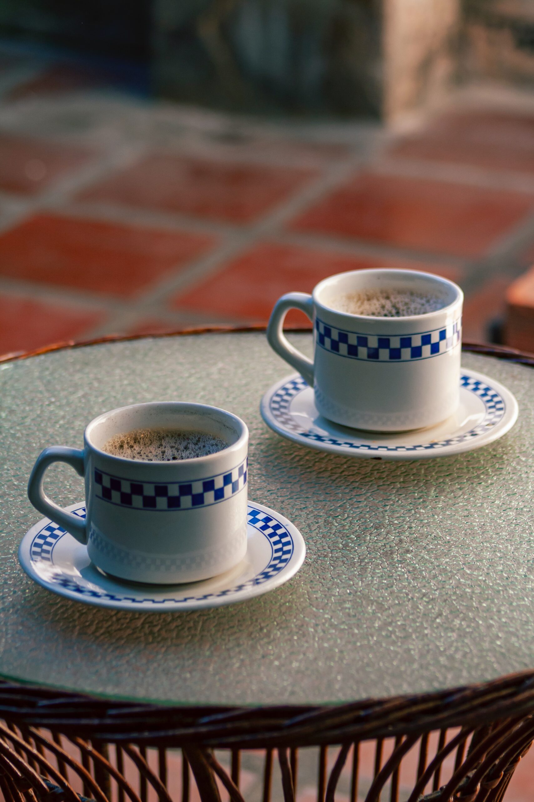 two cups of coffee sitting on top of a table